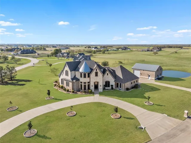 an aerial view of a house with outdoor space and ocean view