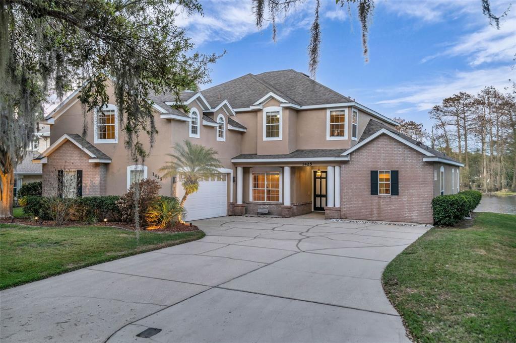 1425 Riviera Drive Kissimmee, FL 34744 - Photo 60 of 82 a front view of a house with a yard and garage