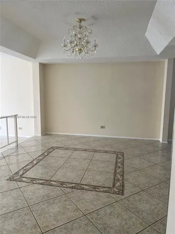 a view of room with a ceiling fan and window