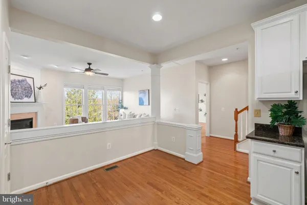 a kitchen with a wooden floor and white appliances