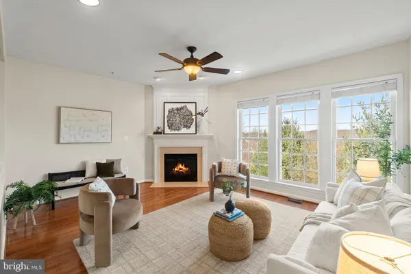 a living room with furniture a chandelier and a fireplace