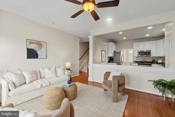 a living room with furniture and kitchen view