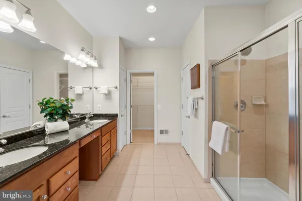a large kitchen with a sink and refrigerator