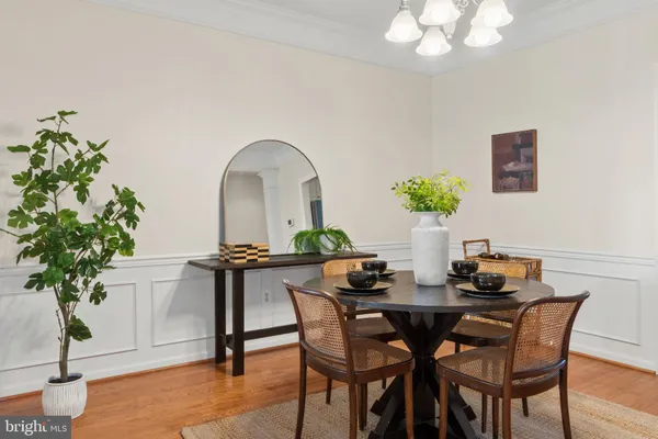 a dining room with furniture and potted plants