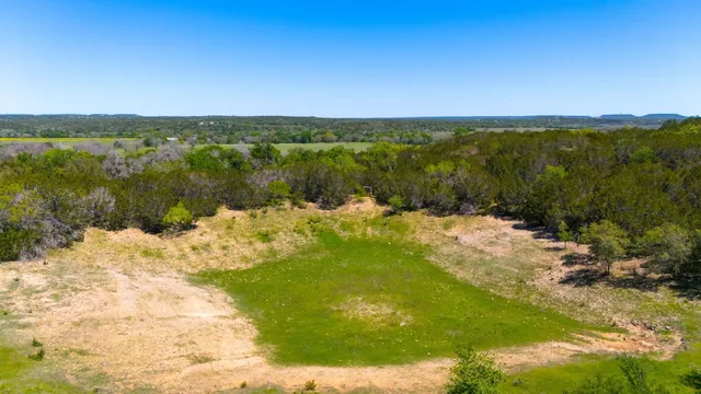 a yellow building with trees in front of it