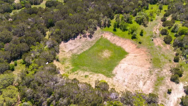 an aerial view of residential houses with city view