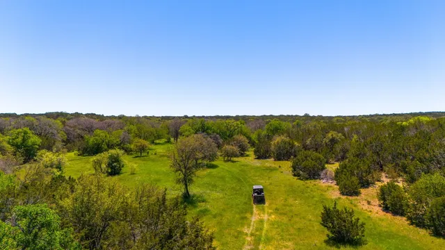 a view of a house with a mountain and a forest