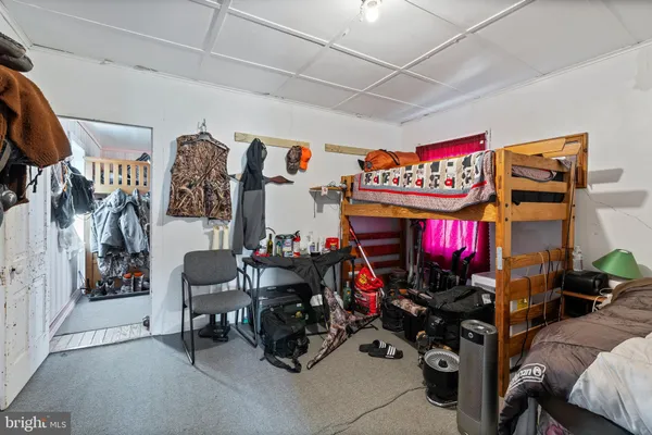 a view of a hallway to a livingroom with furniture and windows