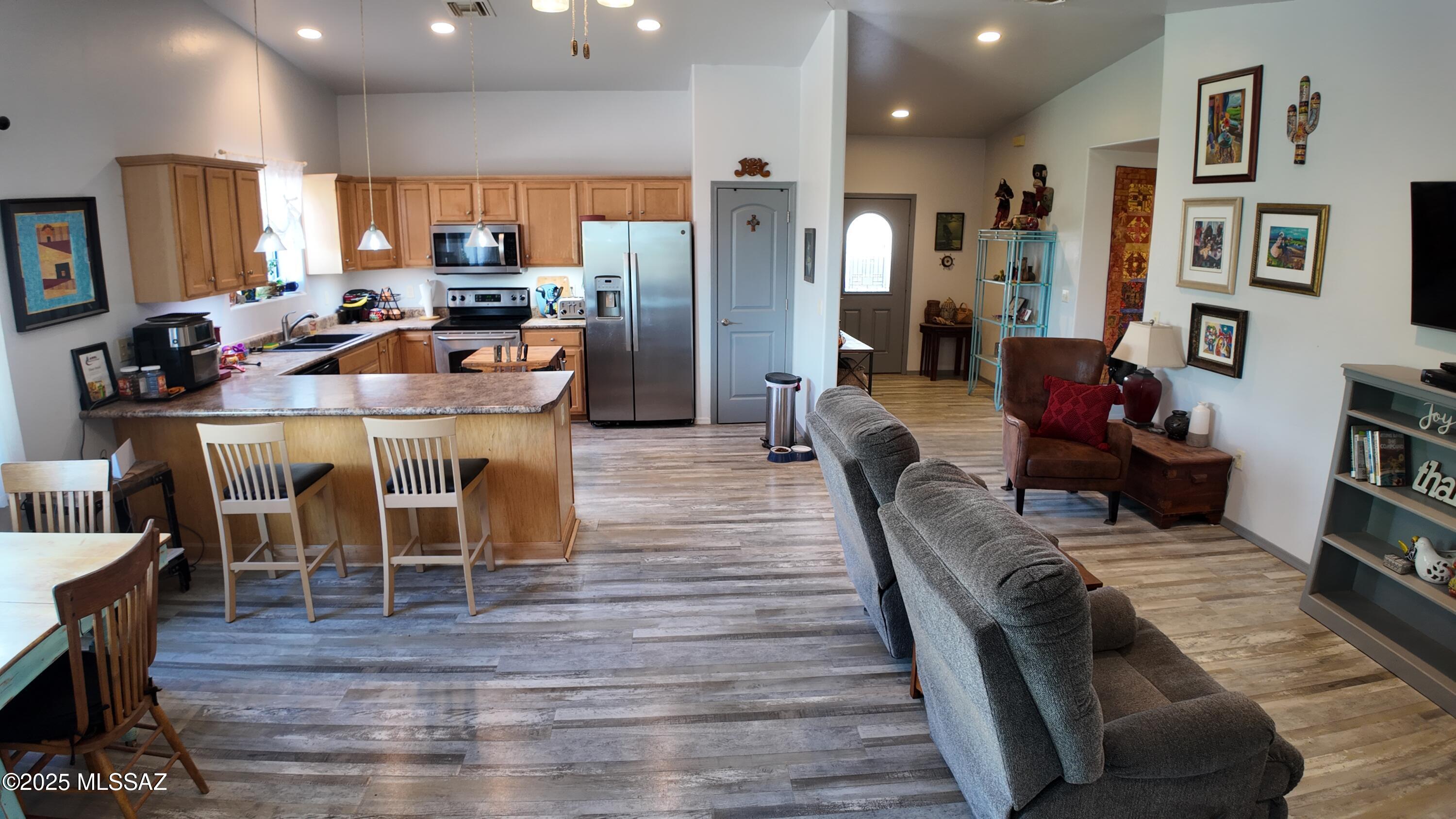 995 Jar Court Rio Rico, AZ 85648 - Photo 12 of 44 a large kitchen with a table and chairs