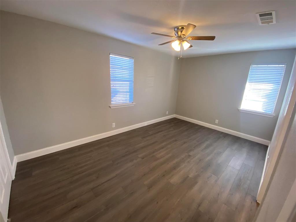 2006 West Northgate Drive Irving, TX 75062 - Photo 14 of 26 wooden floor in an empty room with a window