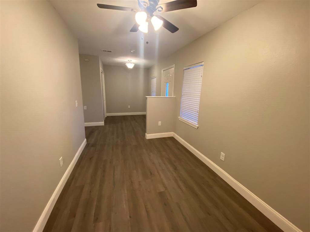 2006 West Northgate Drive Irving, TX 75062 - Photo 15 of 26 wooden floor in an empty room with a window