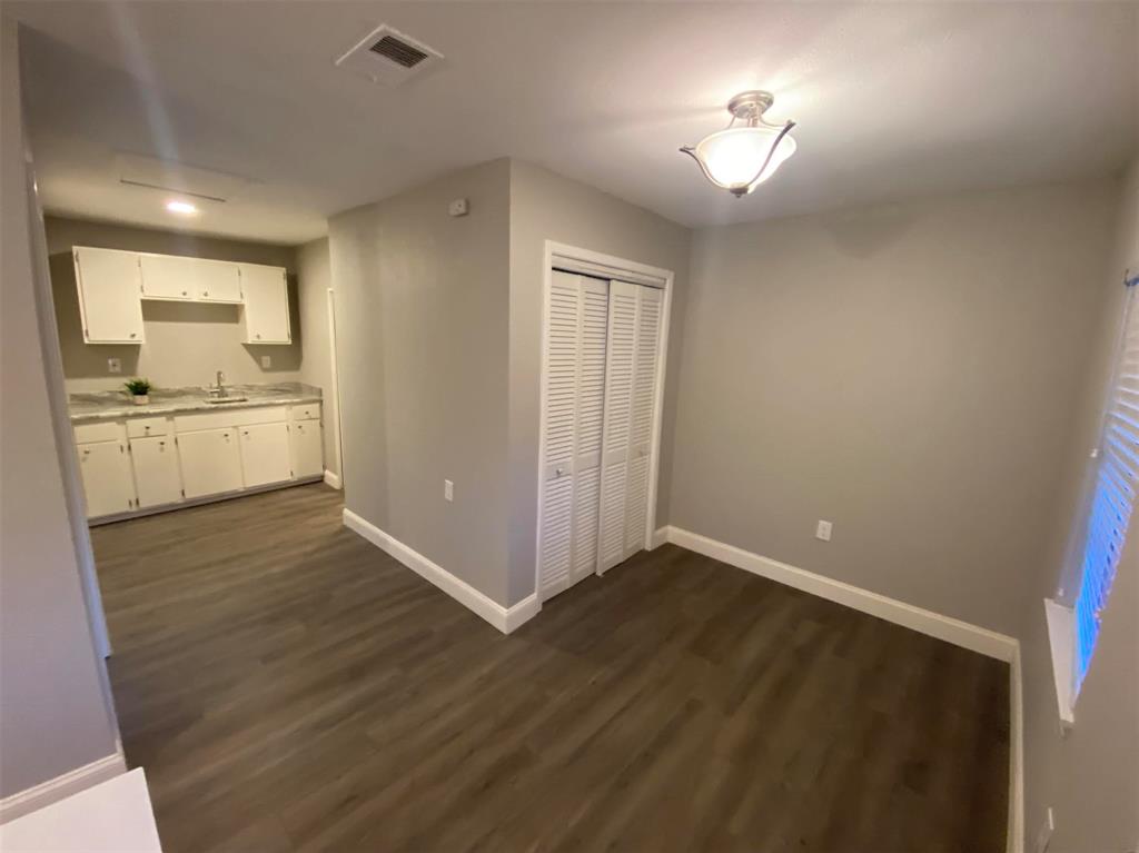 2006 West Northgate Drive Irving, TX 75062 - Photo 16 of 26 a view of empty room with wooden floor and fan