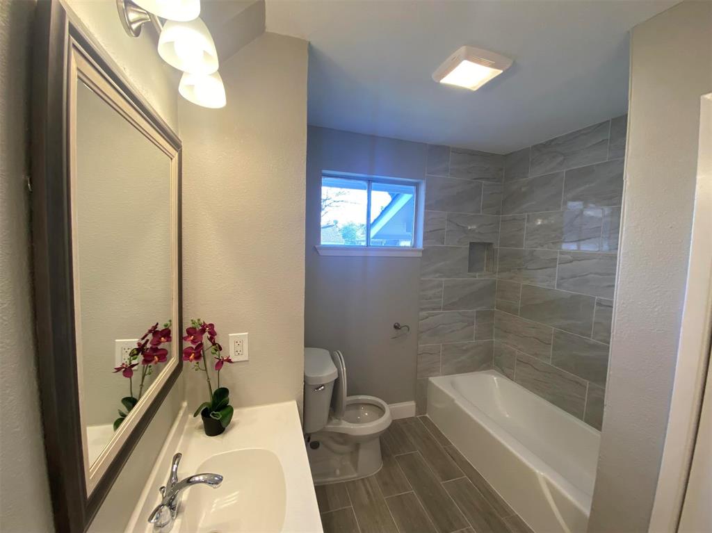 2006 West Northgate Drive Irving, TX 75062 - Photo 17 of 26 a bathroom with a sink a toilet and shower