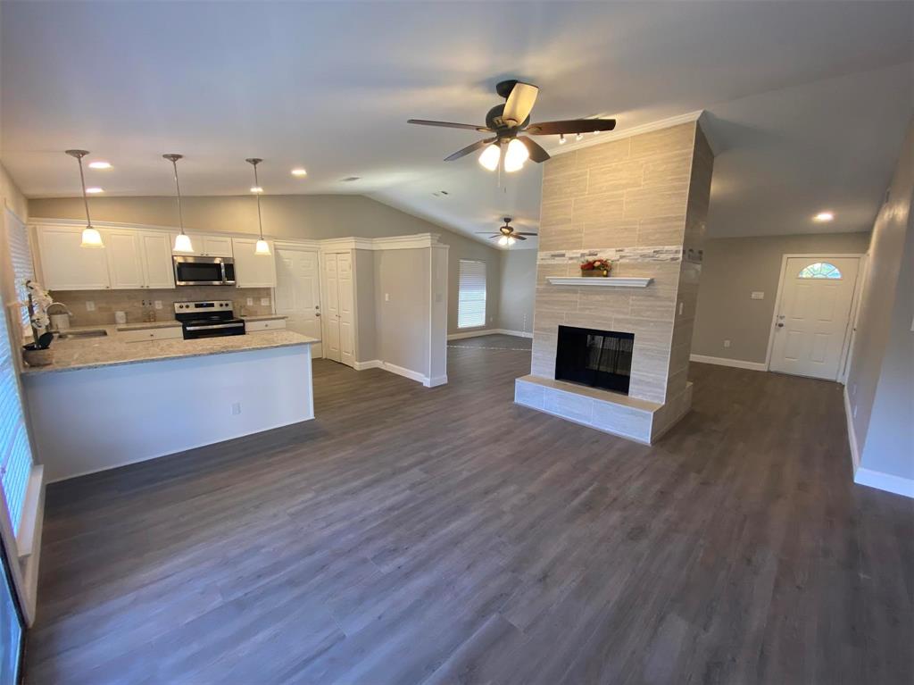2006 West Northgate Drive Irving, TX 75062 - Photo 4 of 26 a view of a kitchen with a sink and a fireplace