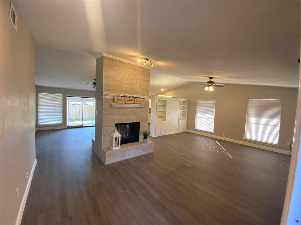 2006 West Northgate Drive Irving, TX 75062 - Photo 5 of 26 a view of empty room with wooden floor and fireplace
