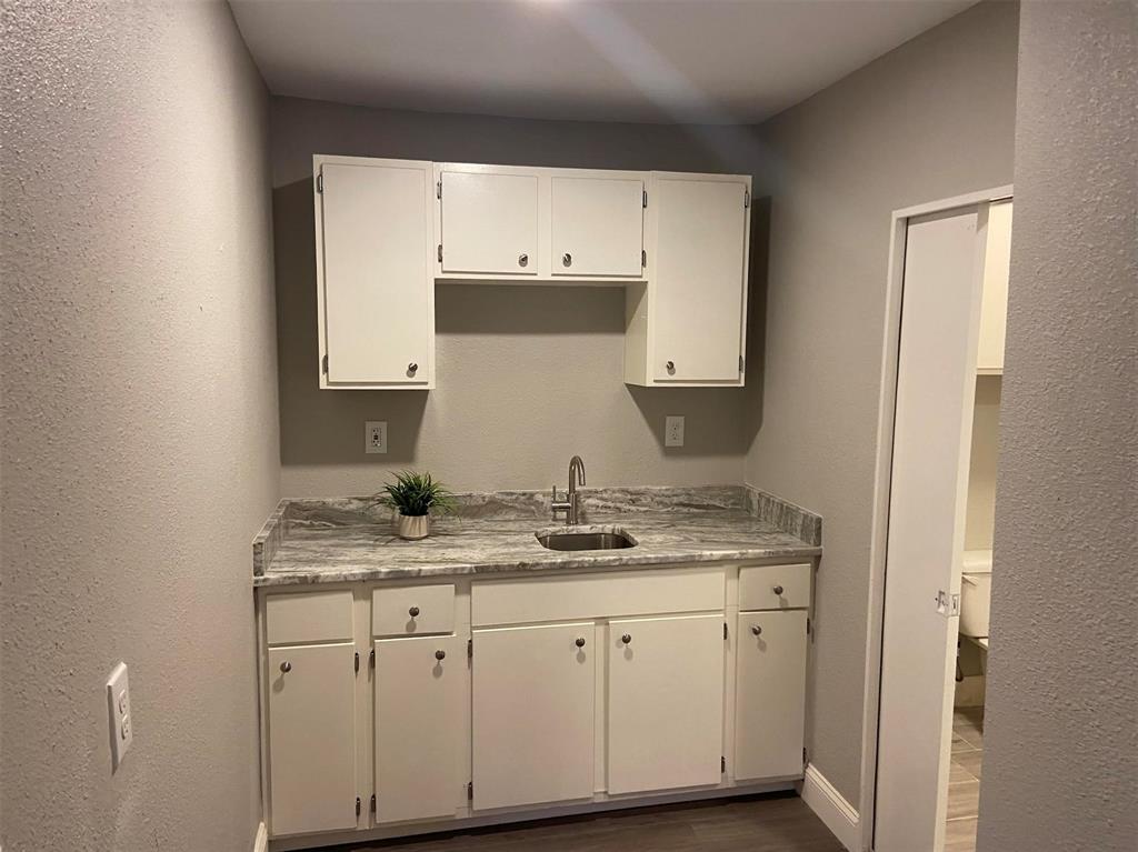 2006 West Northgate Drive Irving, TX 75062 - Photo 10 of 26 a bathroom with a granite countertop sink and a mirror