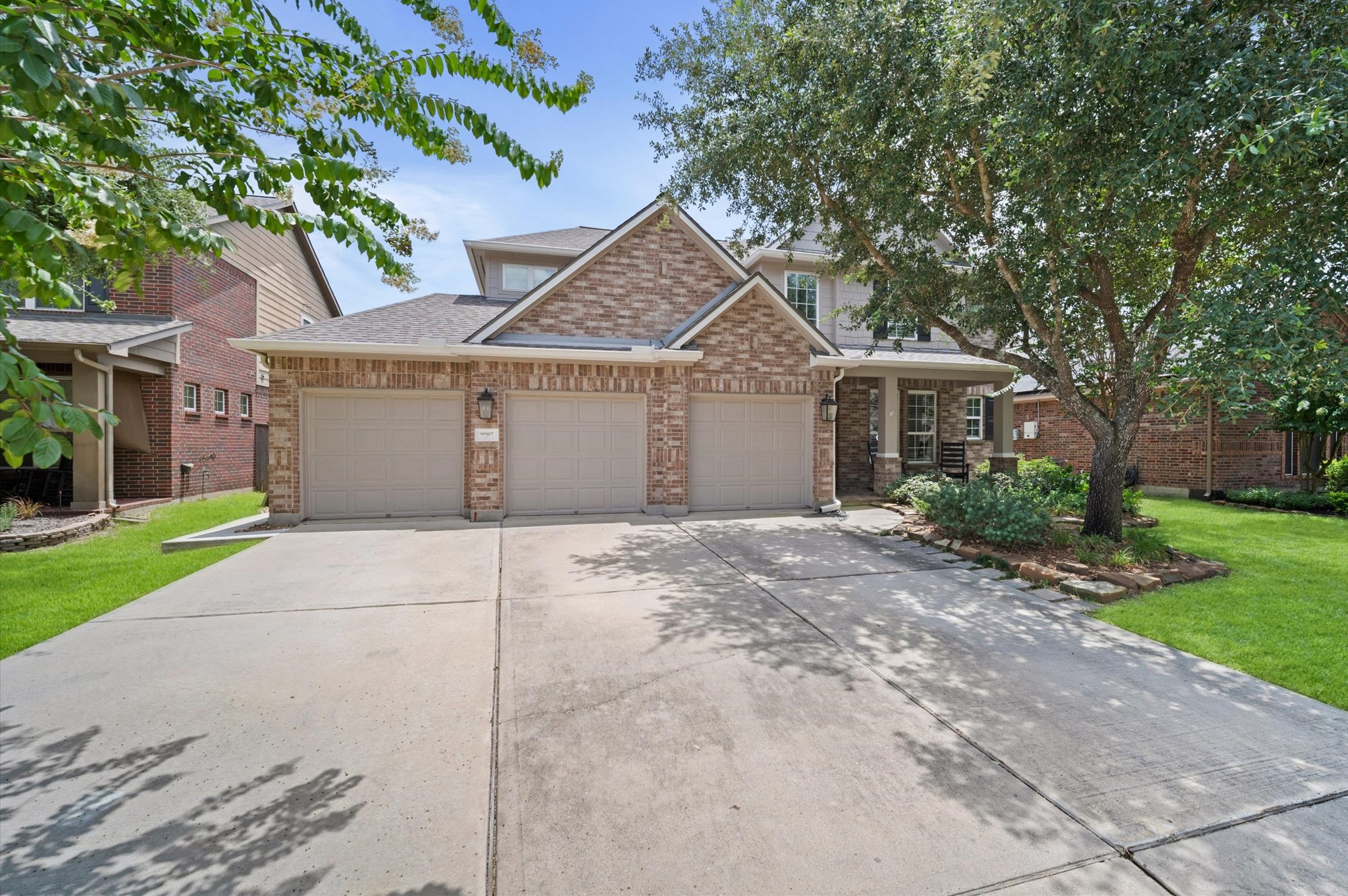 9507 Empress Crossing Drive Spring, TX 77379 - Photo 3 of 50 This charming two-story brick home features a three-car garage and a spacious driveway. The well-maintained front yard includes mature trees and landscaping, providing a welcoming and serene entrance.