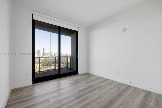 a living room with furniture and large windows
