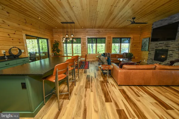 an outdoor sitting area with furniture and wooden floor