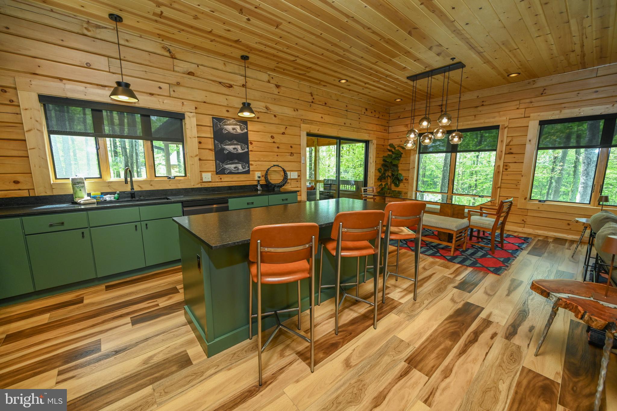 1067 North Camp Road McHenry, MD 21541 - Photo 13 of 81 a view of a dining room with furniture a chandelier and wooden floor