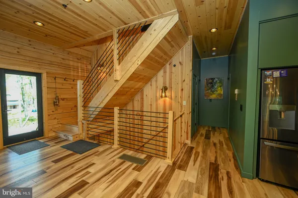 a bed sitting in a bedroom next to a brick wall