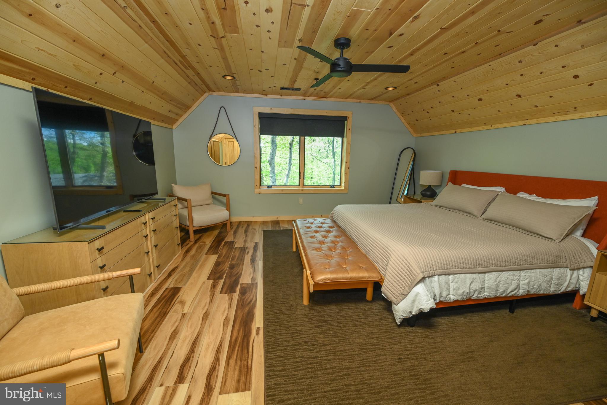 1067 North Camp Road McHenry, MD 21541 - Photo 29 of 81 a spacious bedroom with a bed and a chandelier