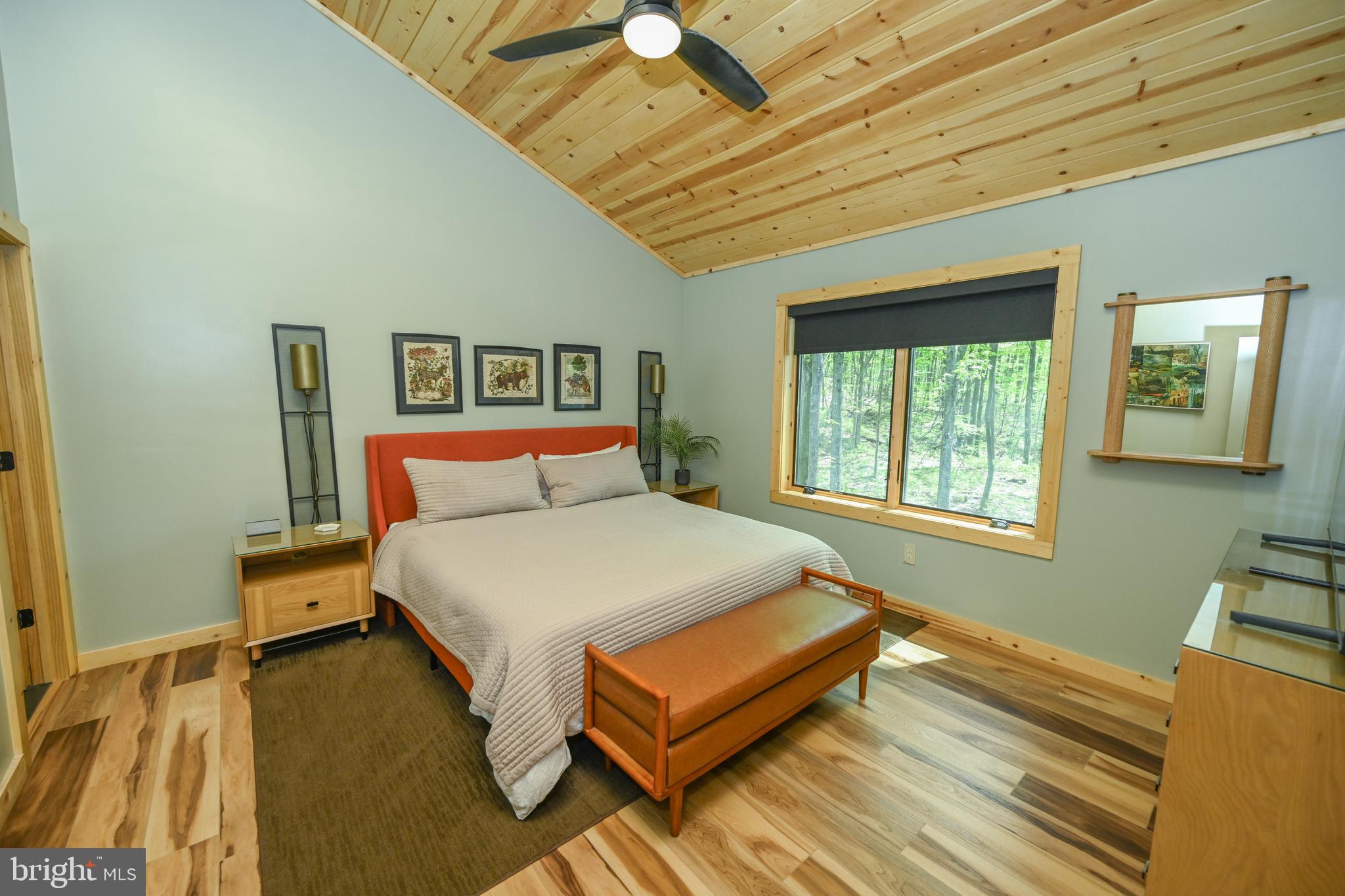 1067 North Camp Road McHenry, MD 21541 - Photo 32 of 81 a bed sitting in a bedroom next to a window