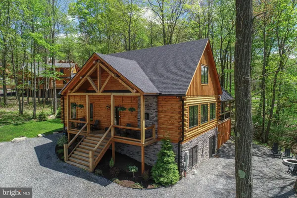 a living room with patio furniture a flat screen tv and a fireplace