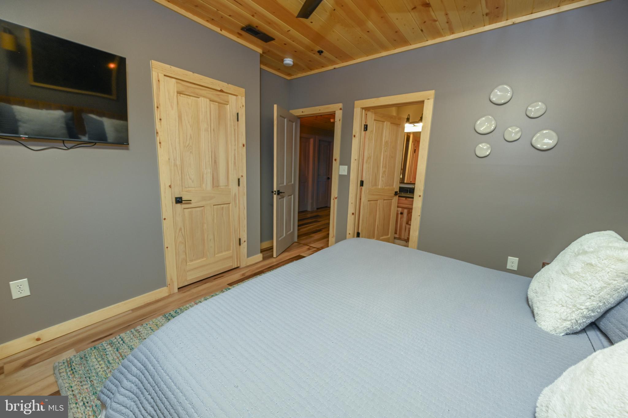 1067 North Camp Road McHenry, MD 21541 - Photo 65 of 81 a bedroom with a bed and a chair