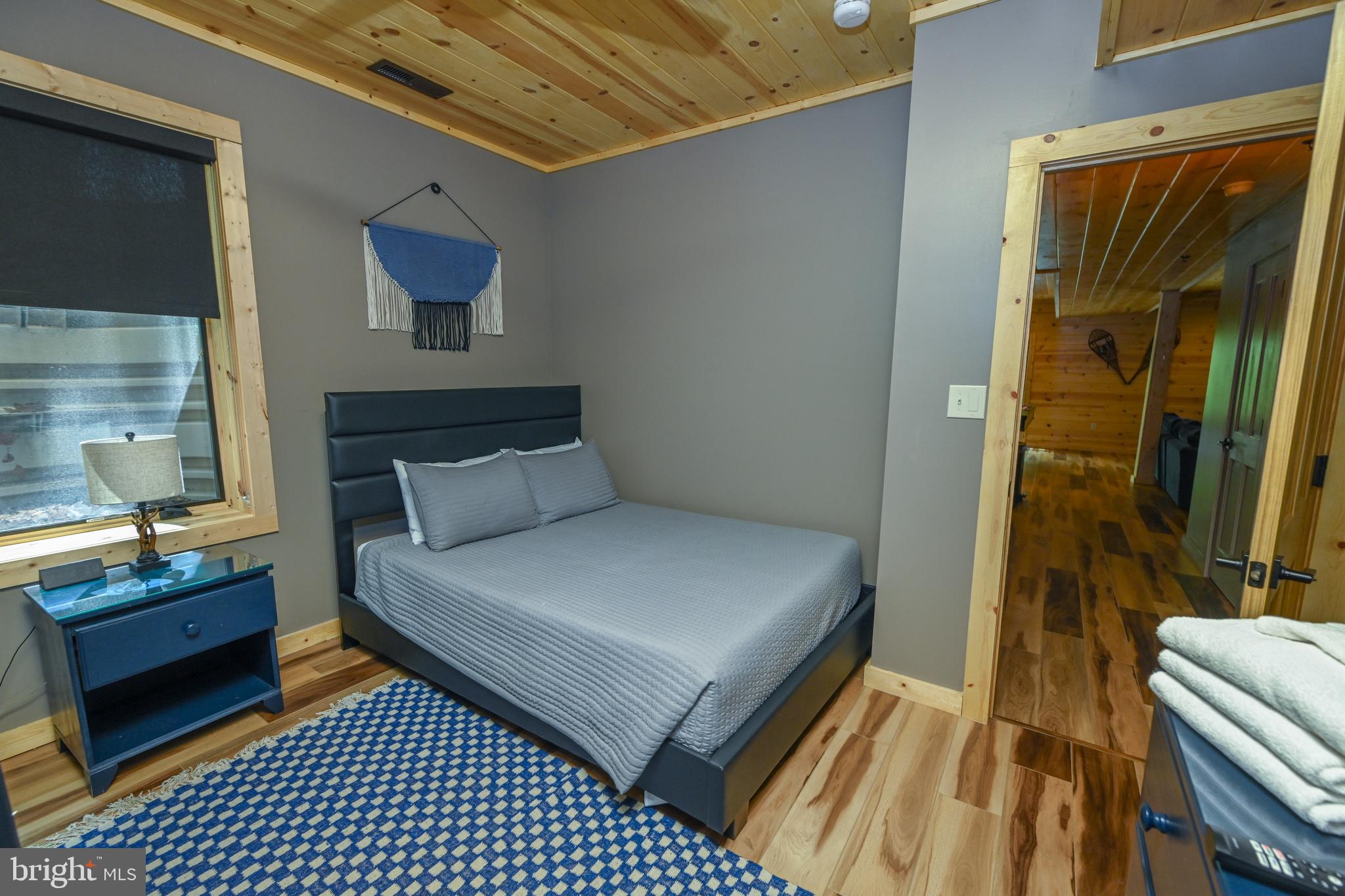 1067 North Camp Road McHenry, MD 21541 - Photo 67 of 81 a bedroom with a bed and a dresser