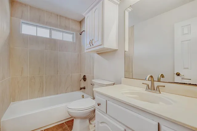 a bathroom with a sink a toilet and bathtub