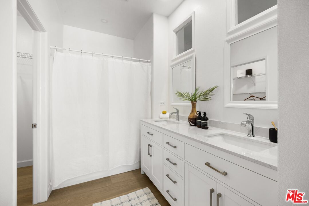 4140 Brookcrest Court Moorpark, CA 93021 - Photo 16 of 27 a bathroom with a double vanity sink and a mirror