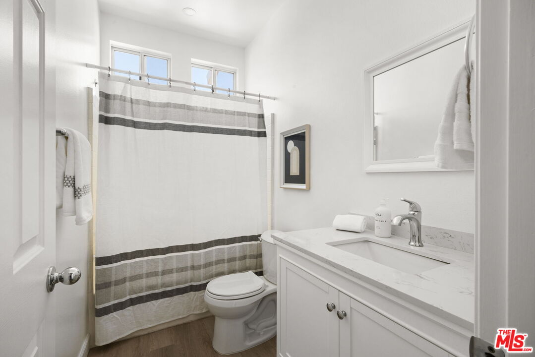 4140 Brookcrest Court Moorpark, CA 93021 - Photo 20 of 27 a bathroom with a granite countertop sink mirror vanity and toilet