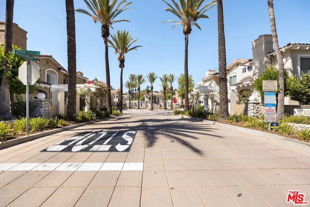 4140 Brookcrest Court Moorpark, CA 93021 - Photo 25 of 27 a front view of a house with a garden and trees