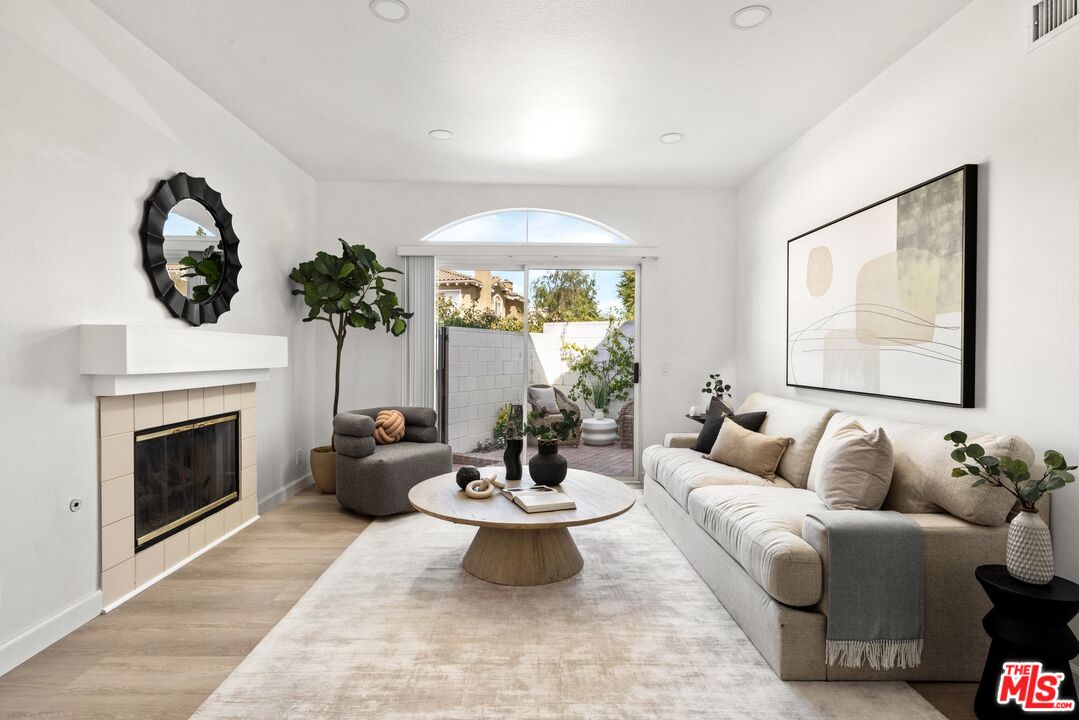 4140 Brookcrest Court Moorpark, CA 93021 - Photo 3 of 27 a living room with furniture a fireplace and a large mirror