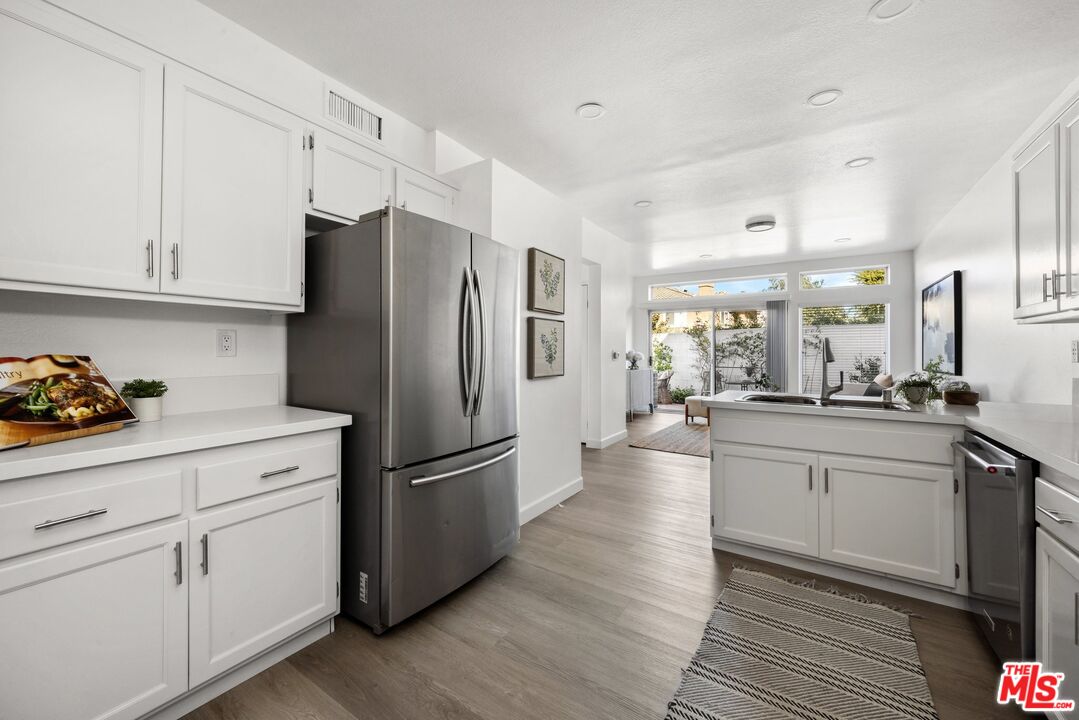 4140 Brookcrest Court Moorpark, CA 93021 - Photo 10 of 27 a kitchen with stainless steel appliances a refrigerator sink and cabinets