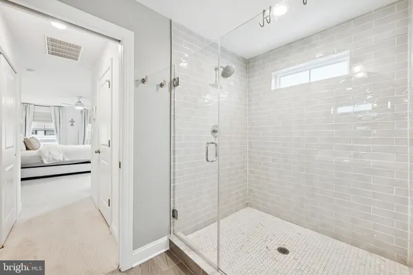 a bathroom with a double vanity sink mirror and next to a window