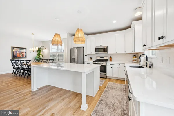 a kitchen with cabinets and wooden floor