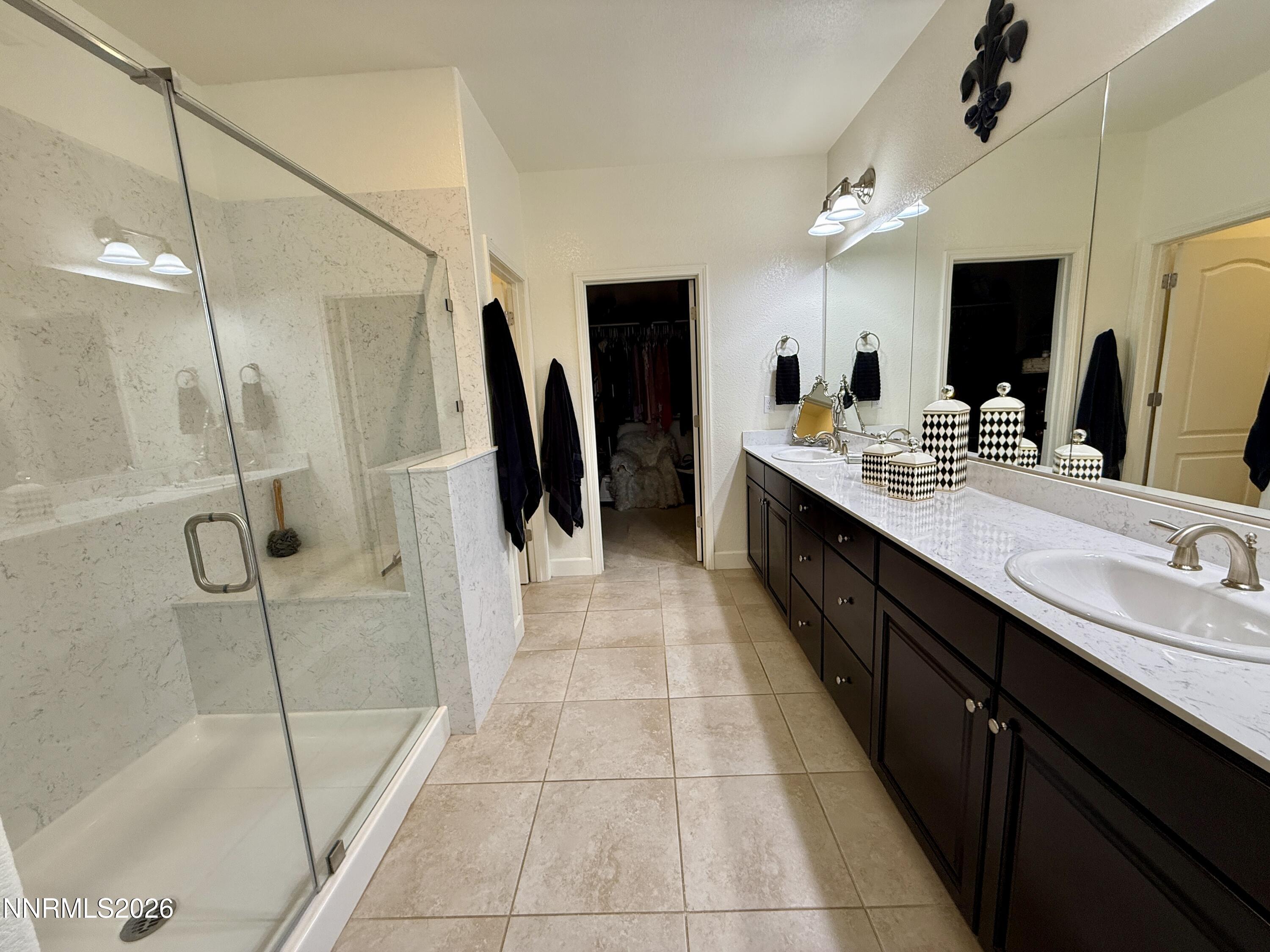 9766 Pachuca Drive Reno, NV 89521 - Photo 28 of 59 a large bathroom with a double vanity sink a large mirror a shower and vanity