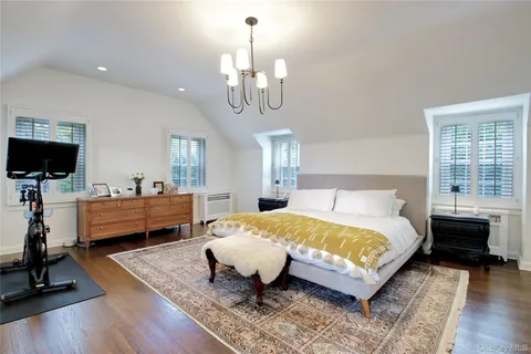 a spacious bedroom with a bed and a fireplace