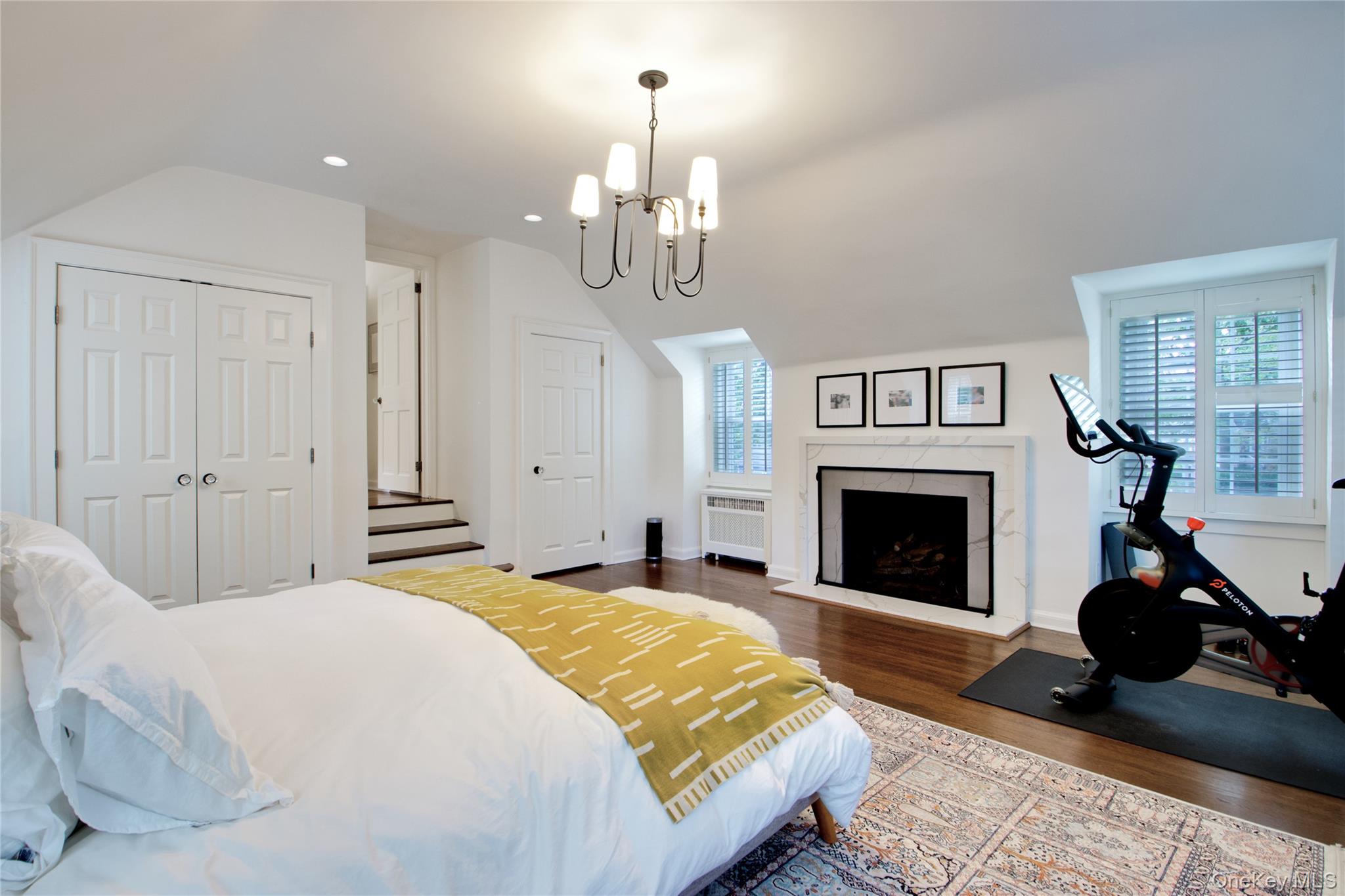 60 Thayer Road Manhasset, NY 11030 - Photo 18 of 28 a spacious bedroom with a bed and a fireplace