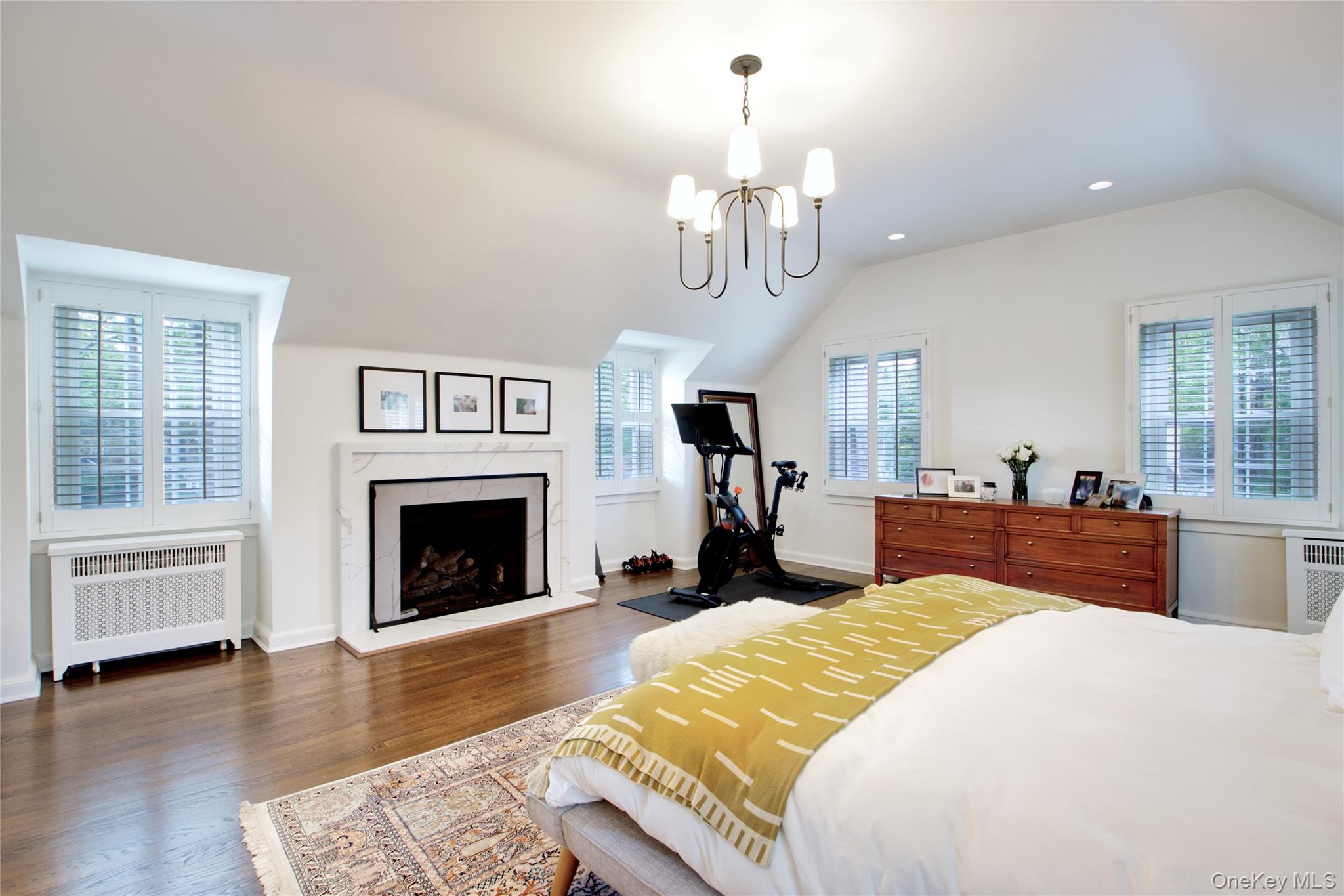 60 Thayer Road Manhasset, NY 11030 - Photo 19 of 28 a spacious bedroom with a bed and a fireplace