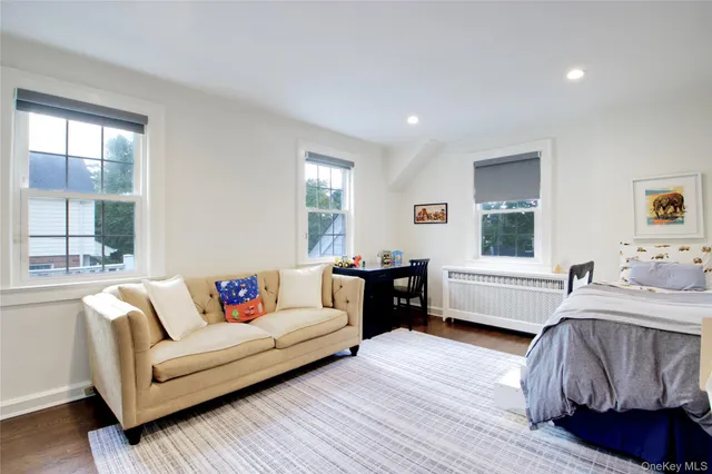a bathroom with a sink toilet a mirror and bathtub