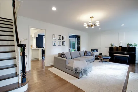 a living room with furniture a lamp and a chandelier
