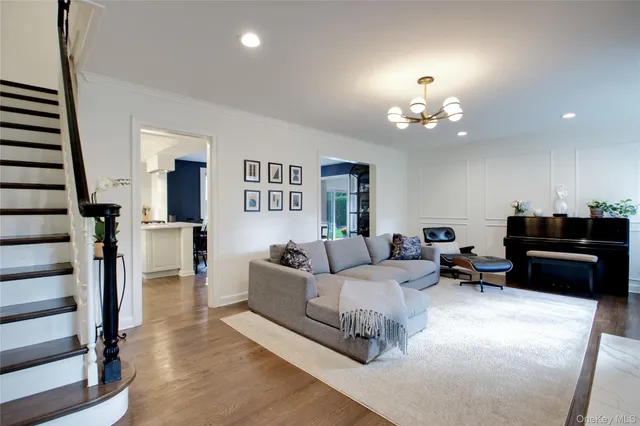 a living room with furniture a lamp and a chandelier