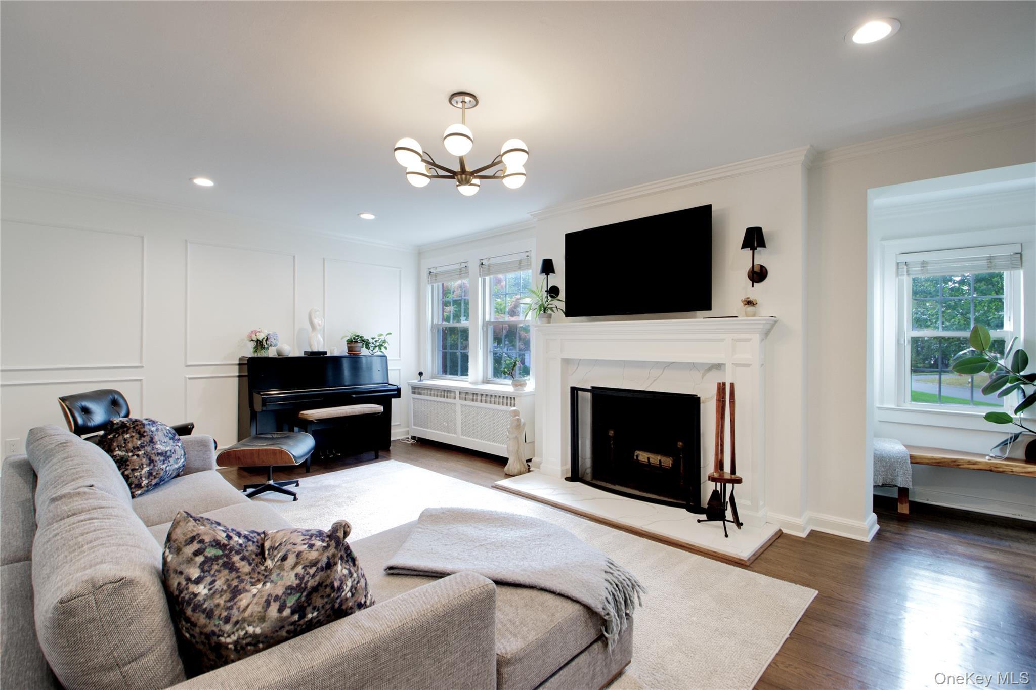 60 Thayer Road Manhasset, NY 11030 - Photo 5 of 28 a living room with furniture a flat screen tv and a fireplace