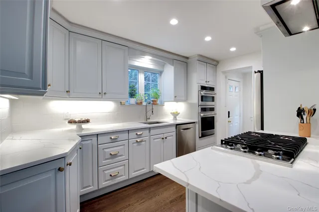 a kitchen with a sink stove and refrigerator