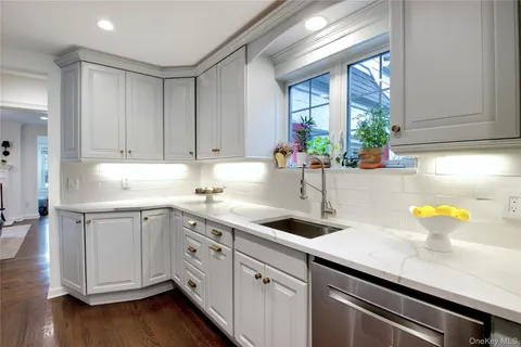a kitchen with stainless steel appliances white cabinets and a sink
