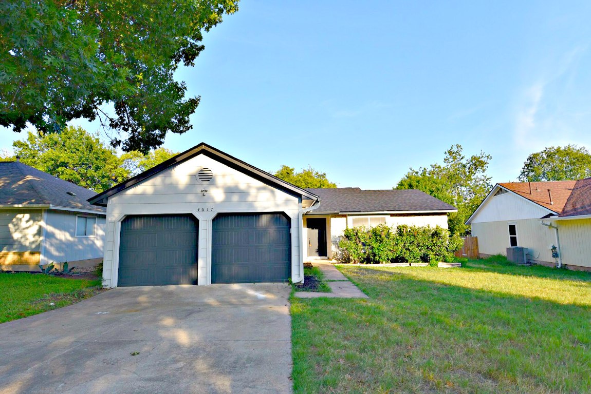 a front view of house with yard and green space