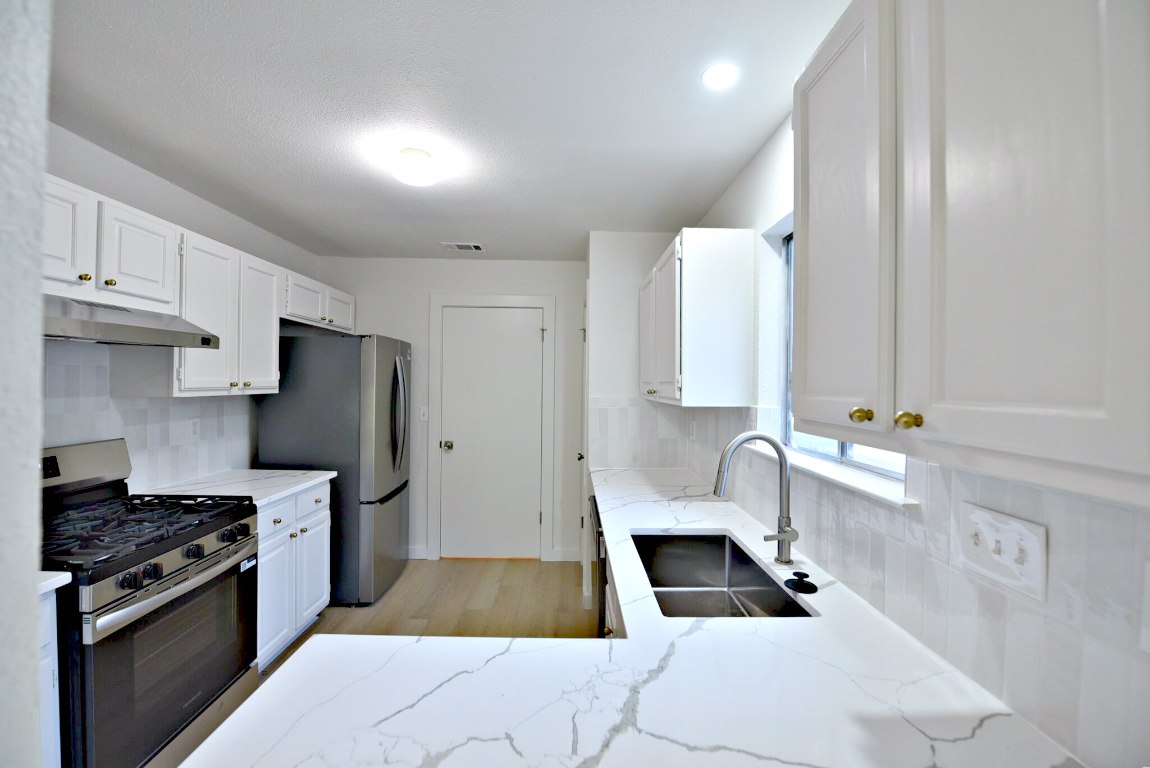 4617 Sidereal Drive Austin, TX 78727 - Photo 11 of 23 a kitchen with a refrigerator and a sink